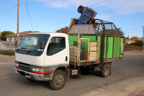 Team standing by a secured skip with safety cones